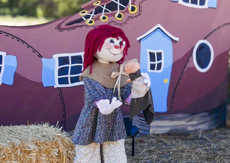Girl and a baby scarecrow