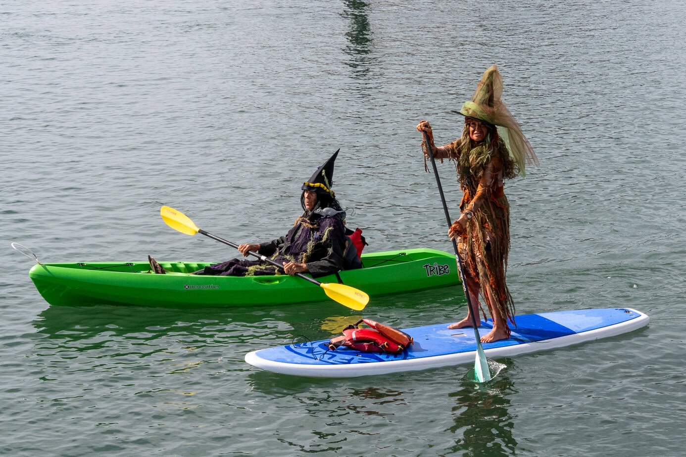 Two costumed paddlers on a kayak and paddleboard during the Witches and Warlocks Paddle in Morro Bay