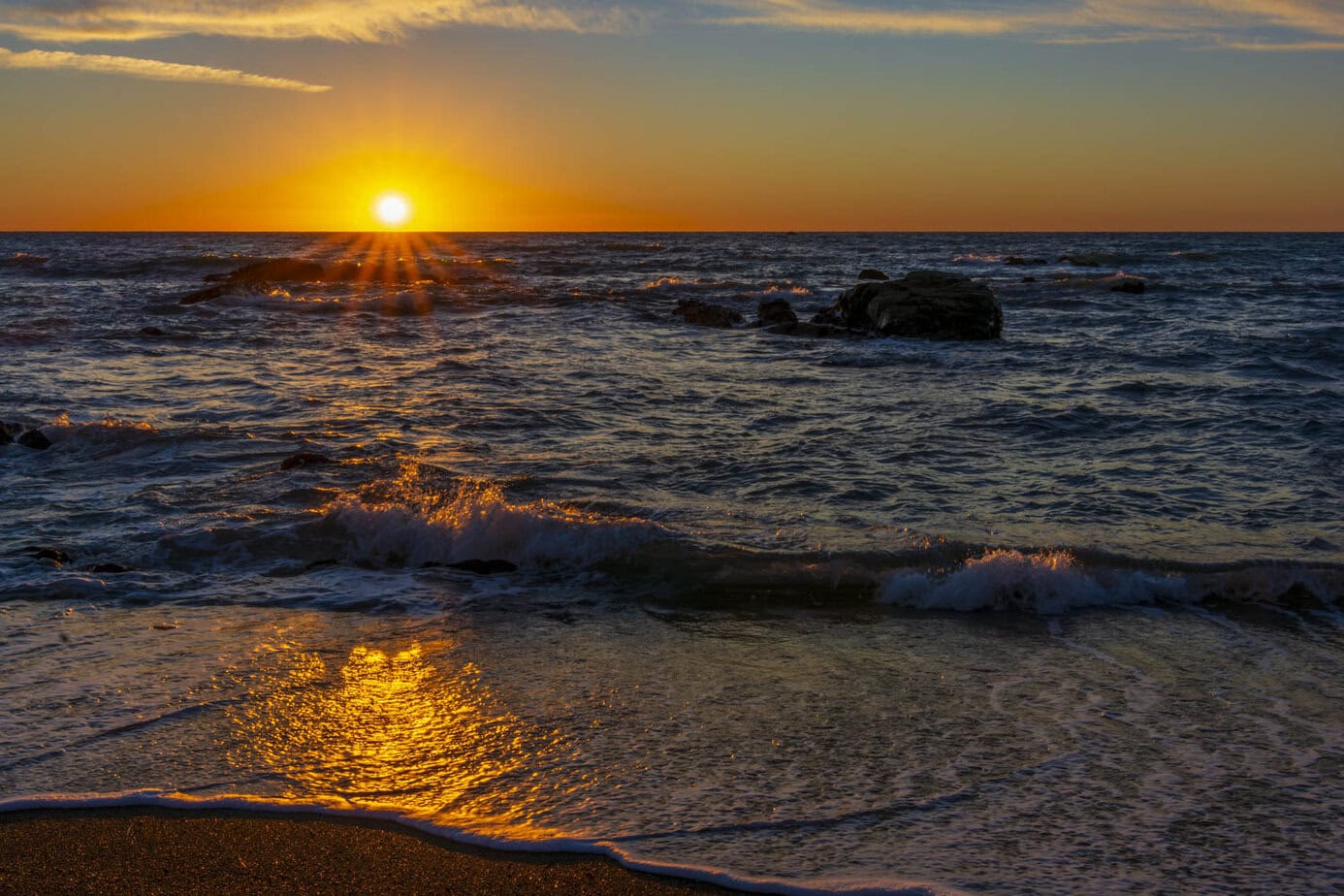 sun setting by moonstone beach in cambria