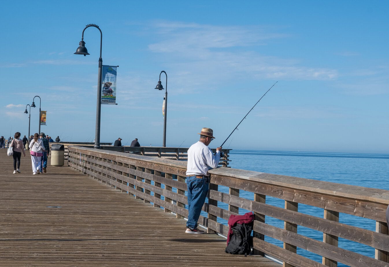 Pismo Beach Pier with a person fishing and ocean views along the California coast