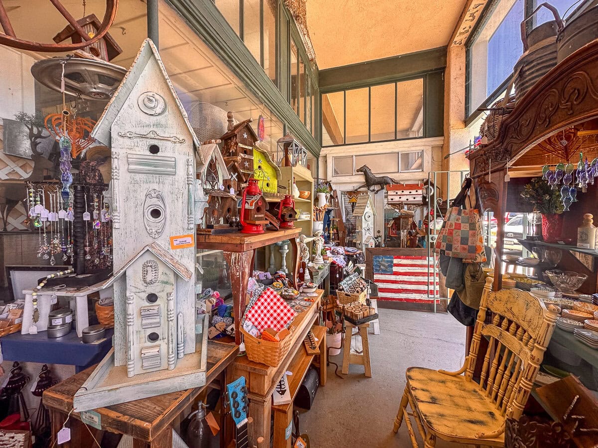 Vintage furniture, decor, and coastal antiques inside an antique shop on Ocean Avenue in Cayucos.
