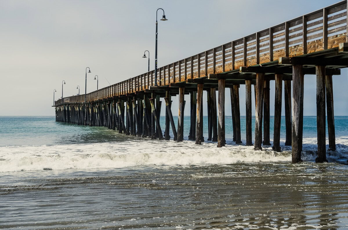 Cayucos Pier extending into the ocean on a quiet, misty morning