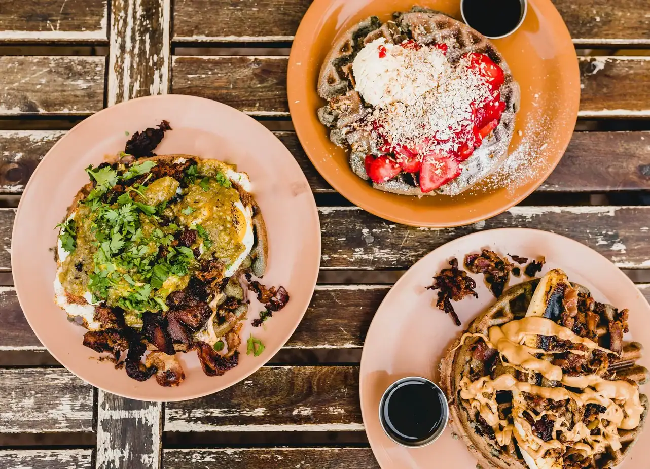 Breakfast spread with blue corn waffle and eggs at Hidden Kitchen in Cayucos.