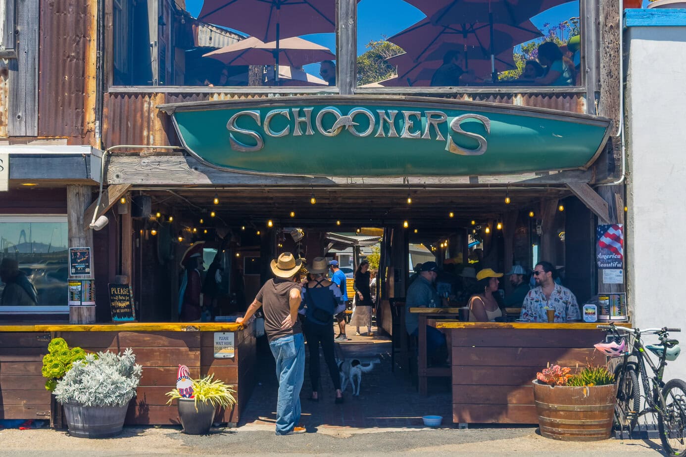Schooners restaurant storefront near Cayucos Pier with outdoor planters.